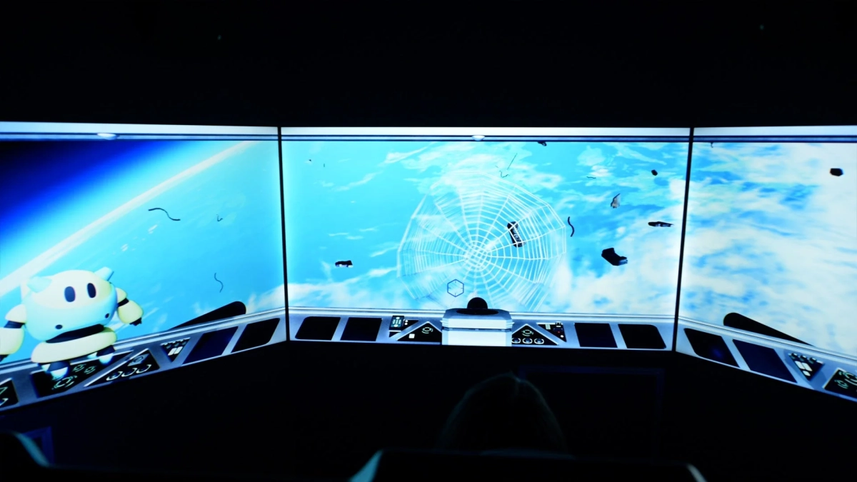 コックピットのような空間から宇宙や地球を思わせるスクリーンを見ている様子