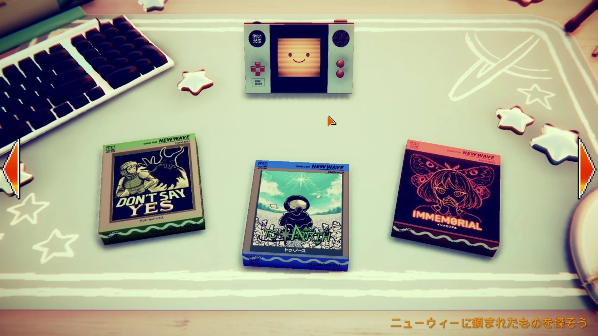 机の上にレトロな携帯ゲーム機と3つのゲームカートリッジが並べられています。ゲーム機には笑顔の顔が表示され、カートリッジには異なるゲームタイトルが書かれています。キーボードや星の飾りが周囲にあり、ゲームプレイを想起させるデスクの風景です。