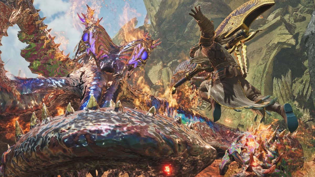 ファンタジー世界で、鎧をまとったハンターが巨大で鮮やかな色彩のモンスターと激しい戦闘を繰り広げている場面