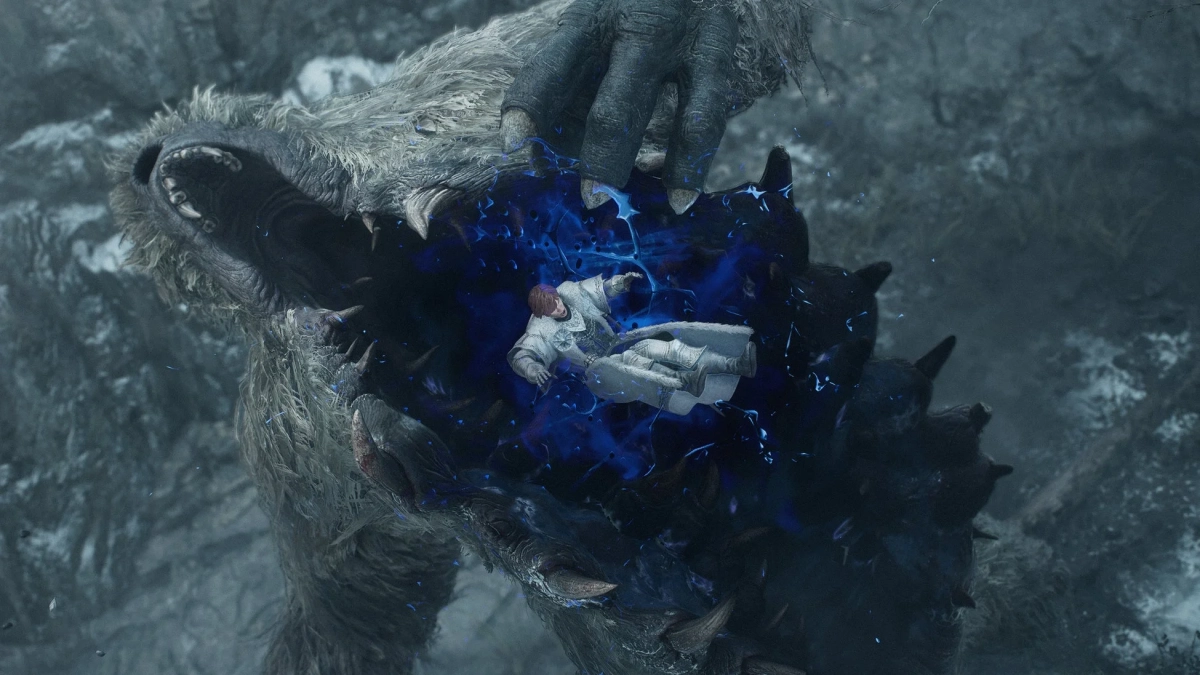 巨大な獣のようなモンスターが人物を捕らえている